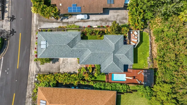 an aerial view of a house with a garden and trees