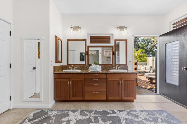 a spacious bathroom with a granite countertop sink and mirror