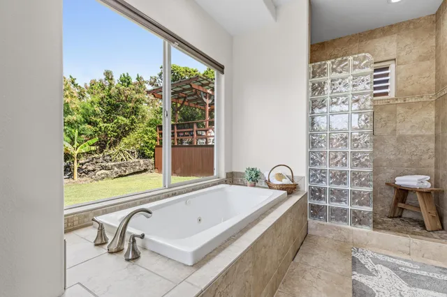 a view of a roof deck with couches chairs and wooden floor