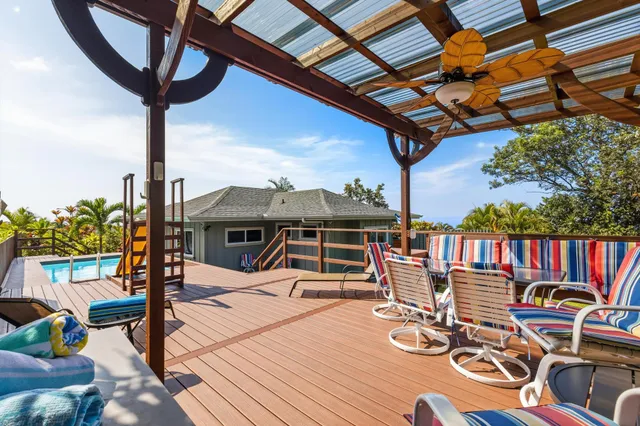 a view of a house with a patio and a yard