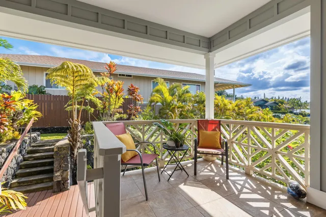 a view of a chairs and table in a balcony