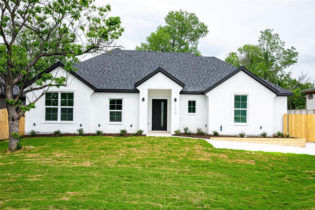 1320 North Peachtree Road Mesquite, TX 75149 - Photo 1 of 1 a front view of a house with a yard