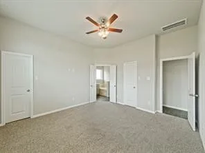 a view of an empty room with a ceiling fan