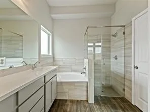 a bathroom with a shower sink vanity and mirror