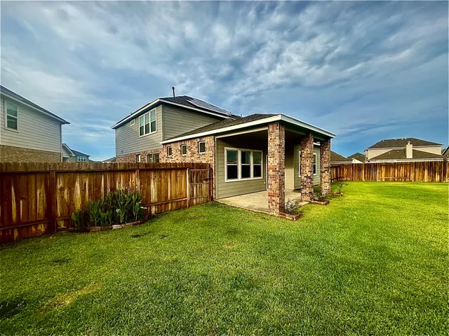 a front view of a house with yard and seating area
