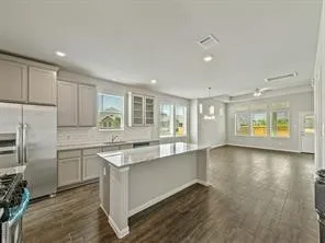 a kitchen with stainless steel appliances granite countertop a stove a sink and a refrigerator