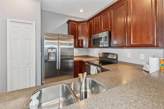 an empty room with windows and ceiling fan