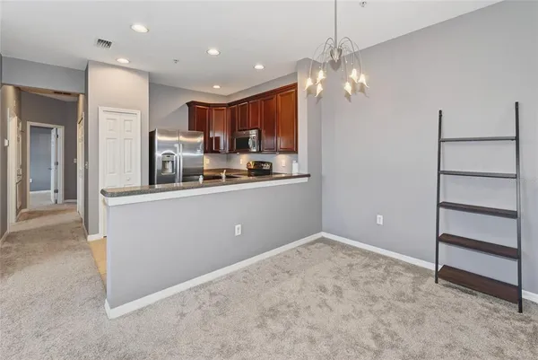 a kitchen with kitchen island a sink stainless steel appliances and cabinets