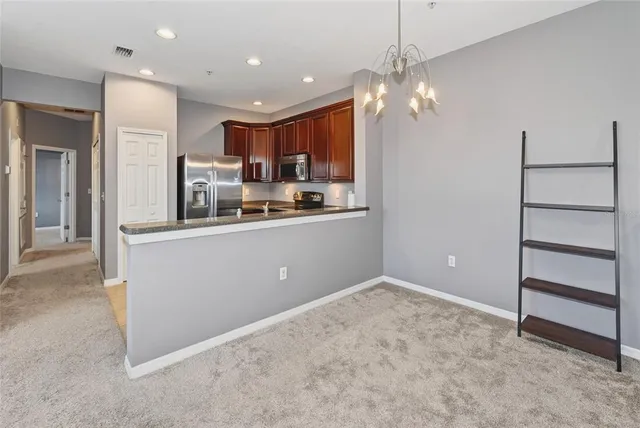 a kitchen with kitchen island a sink stainless steel appliances and cabinets