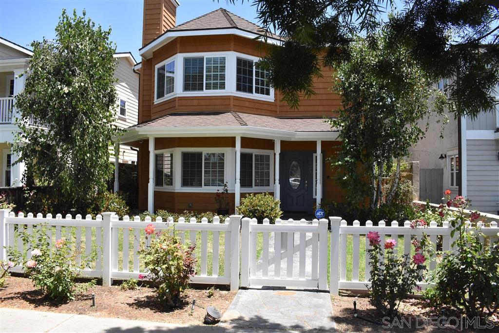 a front view of a house with a yard and flowers