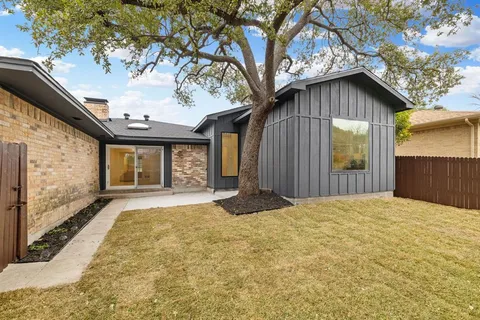 a yellow house with trees in front of it