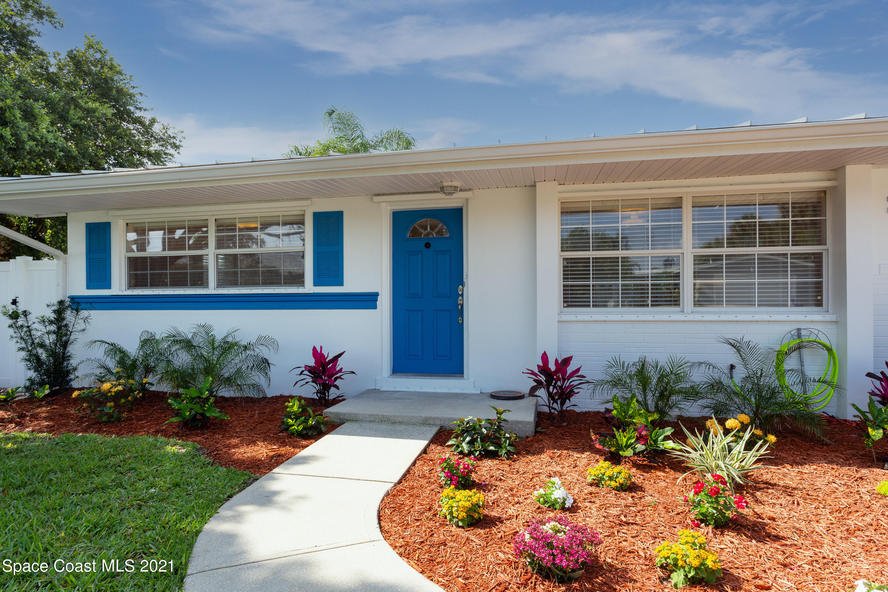 370 Capri Road Cocoa Beach, FL 32931 - Photo 2 of 21 front view of a house with a chairs