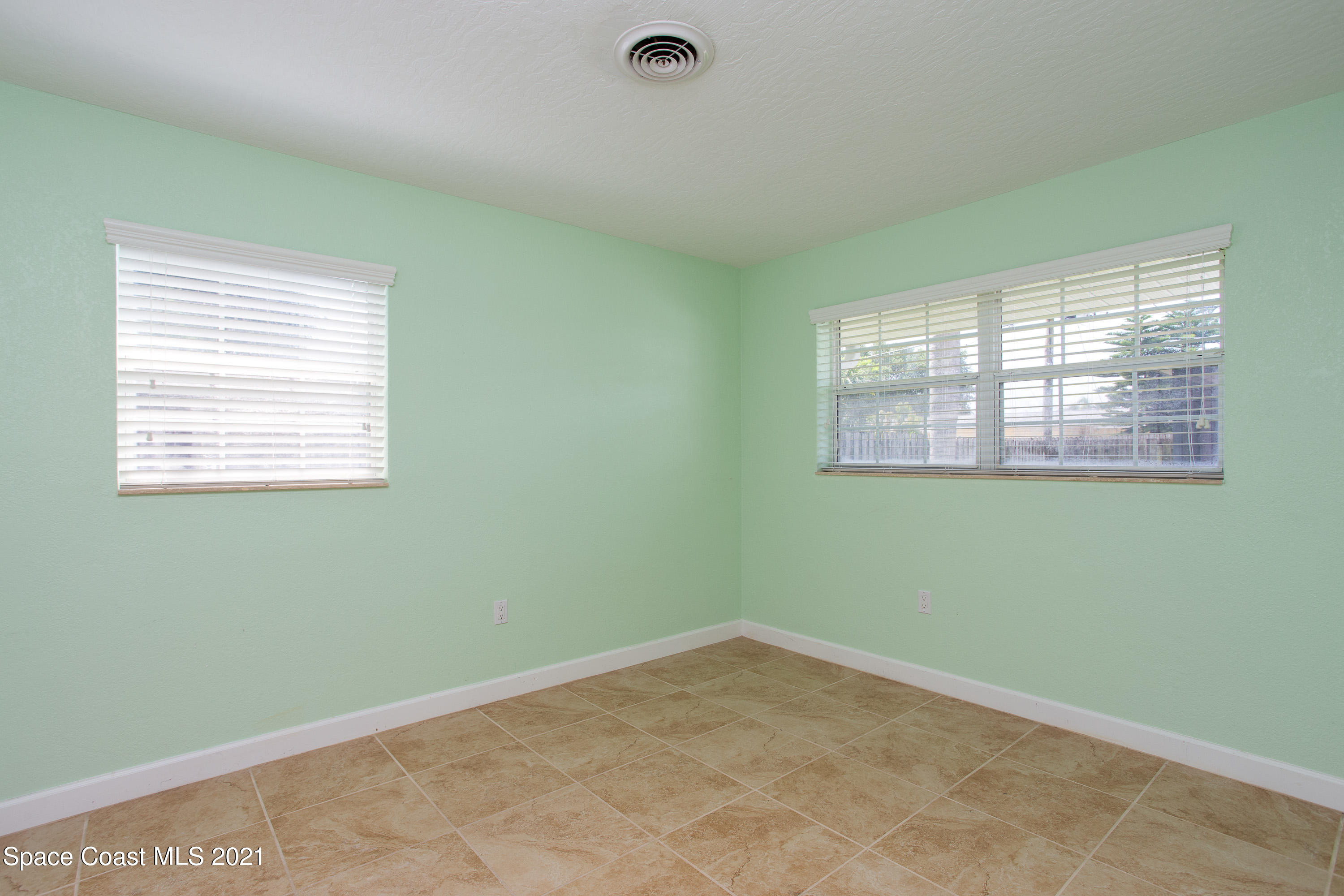 370 Capri Road Cocoa Beach, FL 32931 - Photo 17 of 21 an empty room with a window
