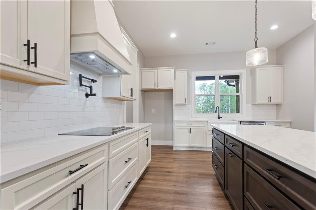 150 Old Sandhill Road Carrollton, GA 30116 - Photo 11 of 36 a kitchen with a sink stove and cabinets