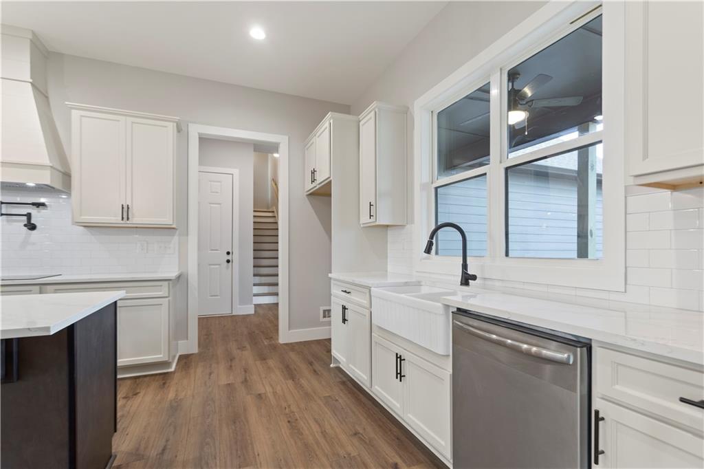 150 Old Sandhill Road Carrollton, GA 30116 - Photo 12 of 36 a kitchen with white cabinets and sink