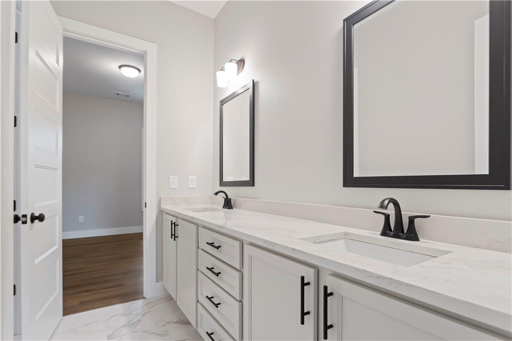 150 Old Sandhill Road Carrollton, GA 30116 - Photo 17 of 36 a bathroom with a double vanity sink and mirror