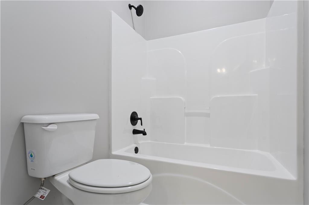 150 Old Sandhill Road Carrollton, GA 30116 - Photo 19 of 36 a white toilet and tub sitting next to a bathroom sink