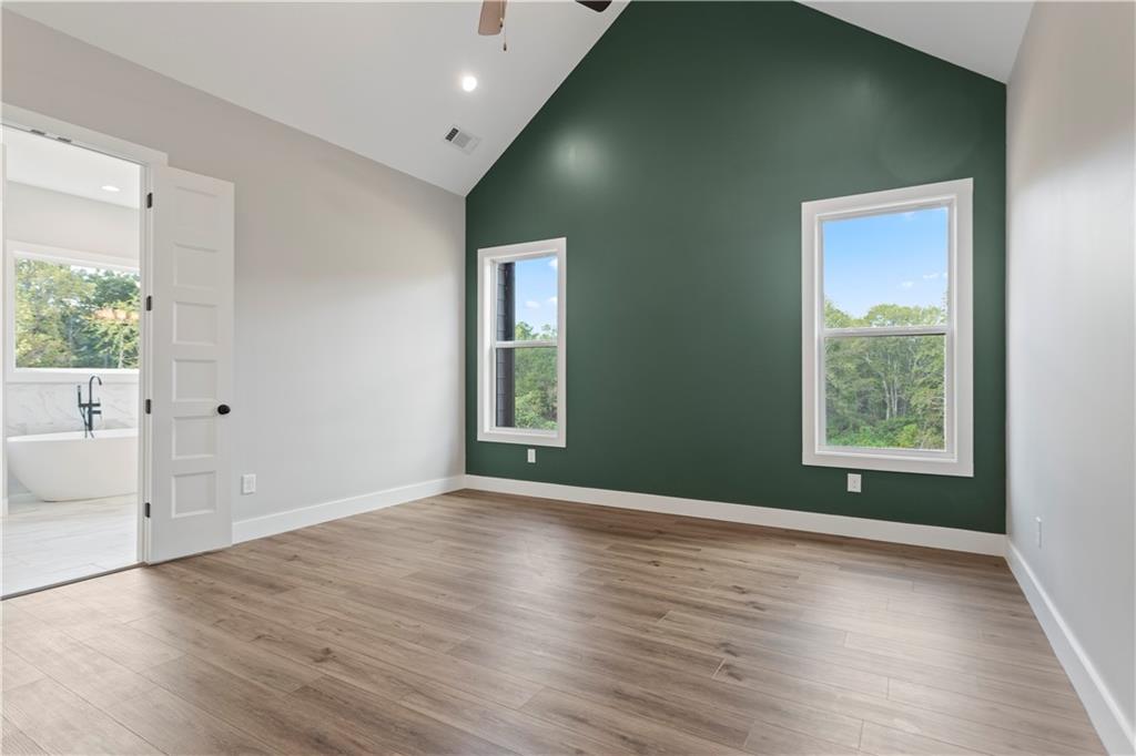 150 Old Sandhill Road Carrollton, GA 30116 - Photo 22 of 36 an empty room with wooden floor and windows