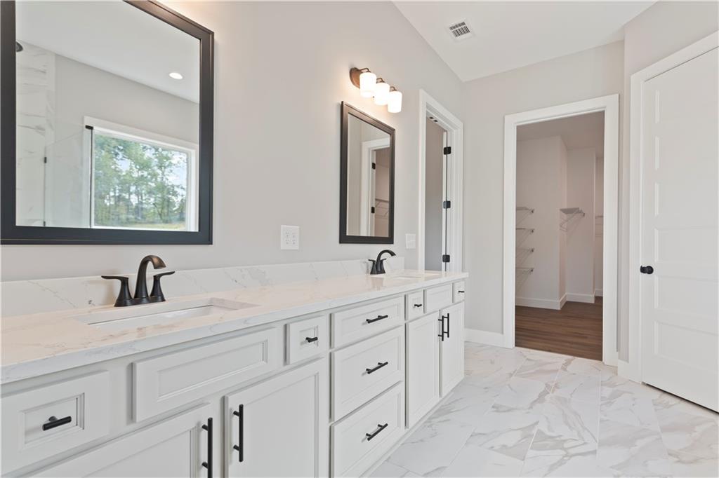 150 Old Sandhill Road Carrollton, GA 30116 - Photo 26 of 36 a bathroom with double sink and a mirror