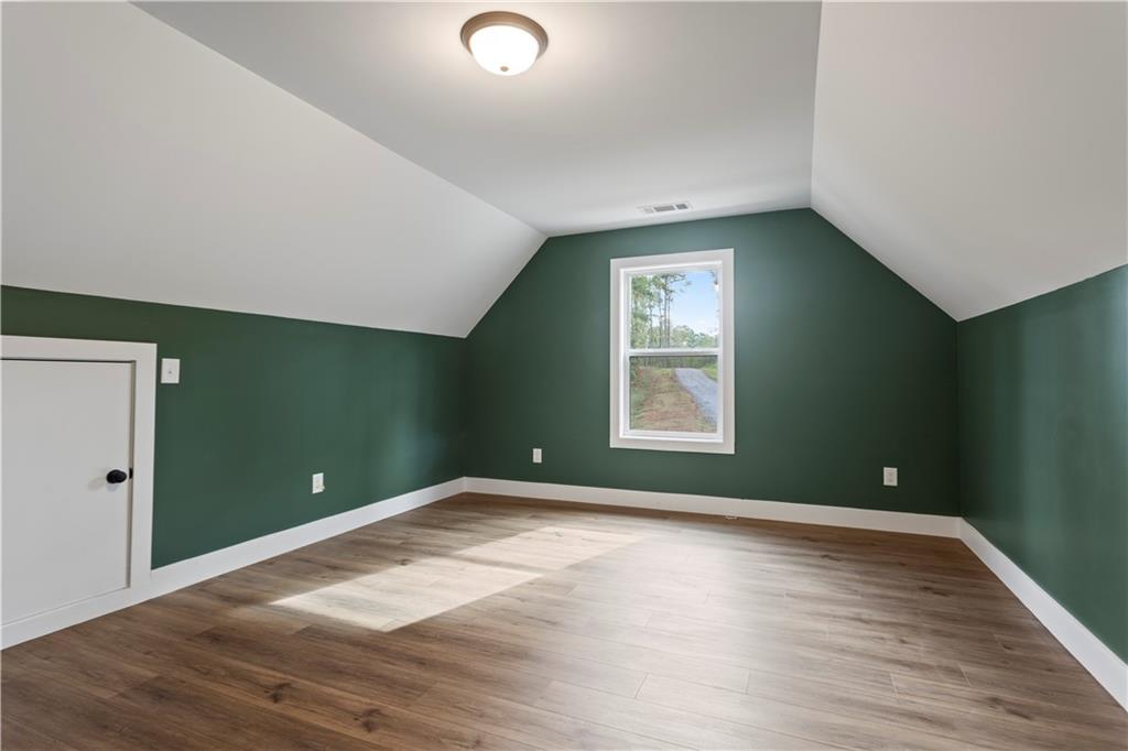 150 Old Sandhill Road Carrollton, GA 30116 - Photo 28 of 36 an empty room with wooden floor and windows