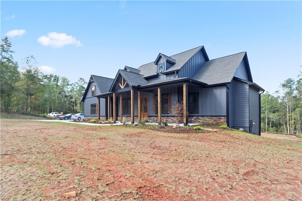 150 Old Sandhill Road Carrollton, GA 30116 - Photo 3 of 36 a front view of a house with a yard and garage