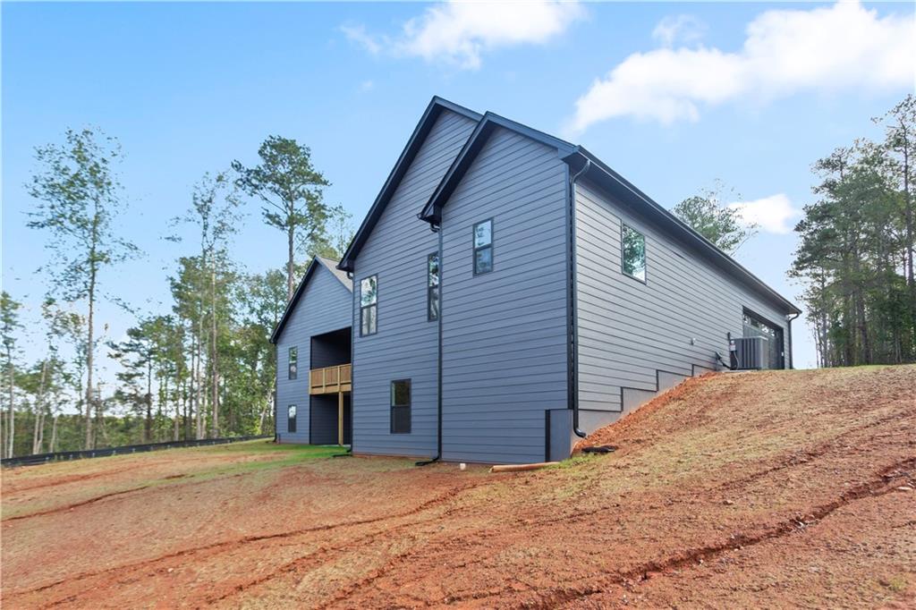 150 Old Sandhill Road Carrollton, GA 30116 - Photo 6 of 36 a front view of house with yard and trees in the background