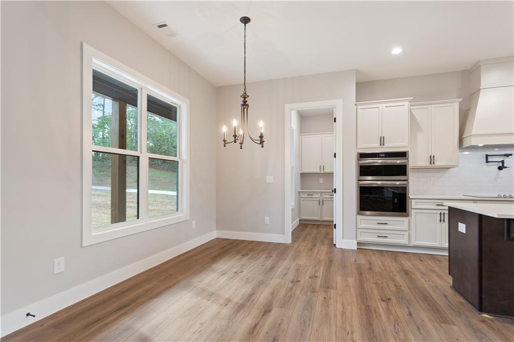 150 Old Sandhill Road Carrollton, GA 30116 - Photo 9 of 36 a view of a kitchen with wooden floor and a ceiling fan