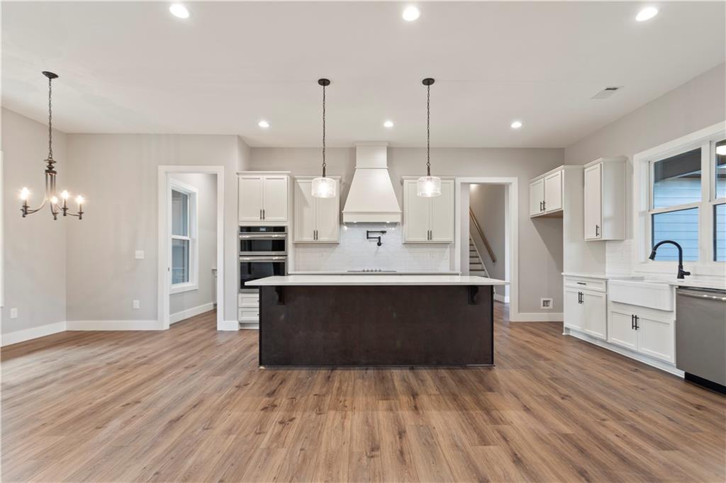 150 Old Sandhill Road Carrollton, GA 30116 - Photo 10 of 36 a large kitchen with a center island wooden floor stainless steel appliances and cabinets