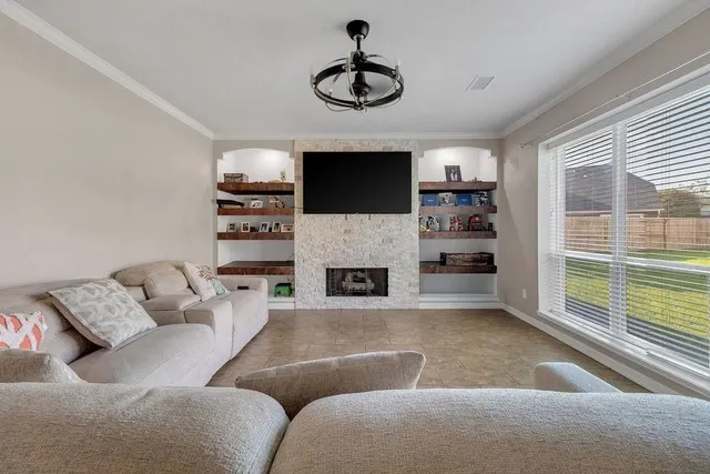 a living room with furniture a fireplace and a flat screen tv