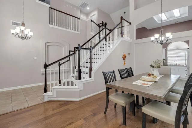 a view of a dining room with furniture and a chandelier