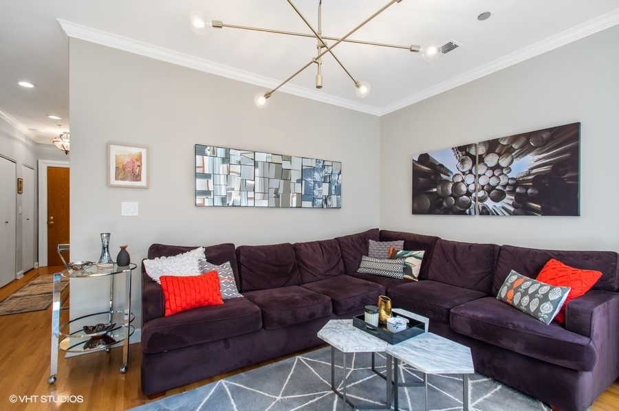 550 West Surf Street, Unit C314 Chicago, IL 60657 - Photo 12 of 21 a living room with furniture a couch and paintings on the wall