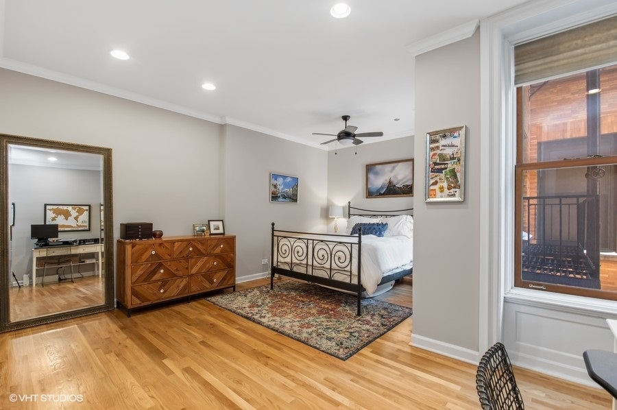 550 West Surf Street, Unit C314 Chicago, IL 60657 - Photo 13 of 21 a bedroom with furniture and a window