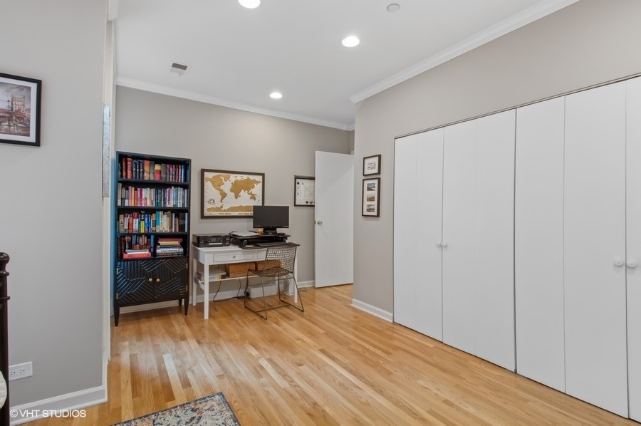 550 West Surf Street, Unit C314 Chicago, IL 60657 - Photo 15 of 21 a workspace with furniture and wooden floor