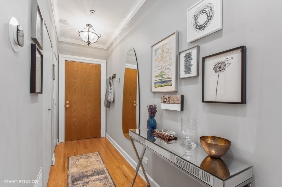 550 West Surf Street, Unit C314 Chicago, IL 60657 - Photo 2 of 21 a view of living room with furniture and a chandelier