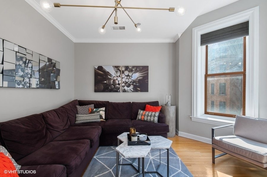 550 West Surf Street, Unit C314 Chicago, IL 60657 - Photo 10 of 21 a living room with furniture and a window