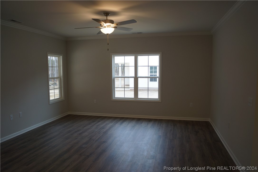111 Knotts Berry Road Bunnlevel, NC 28323 - Photo 23 of 32 an empty room with wooden floor and windows