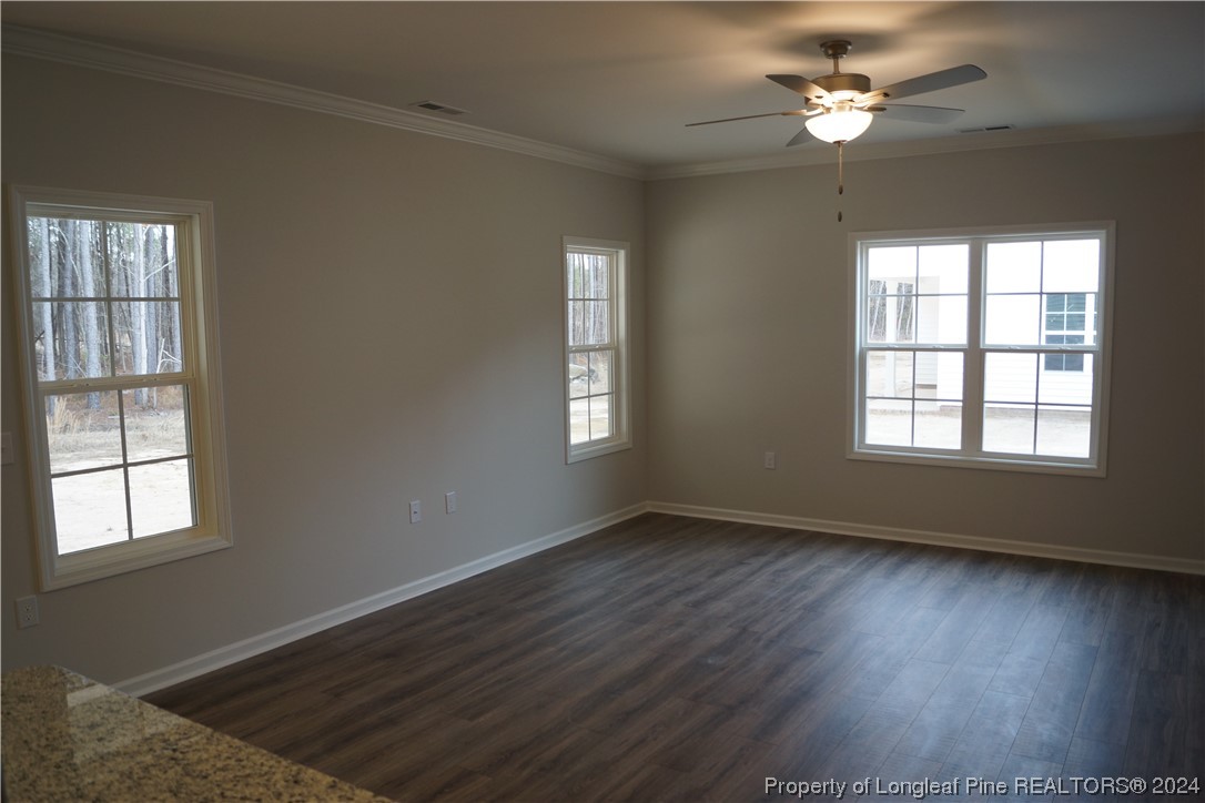 111 Knotts Berry Road Bunnlevel, NC 28323 - Photo 24 of 32 a view of an empty room with wooden floor and a window
