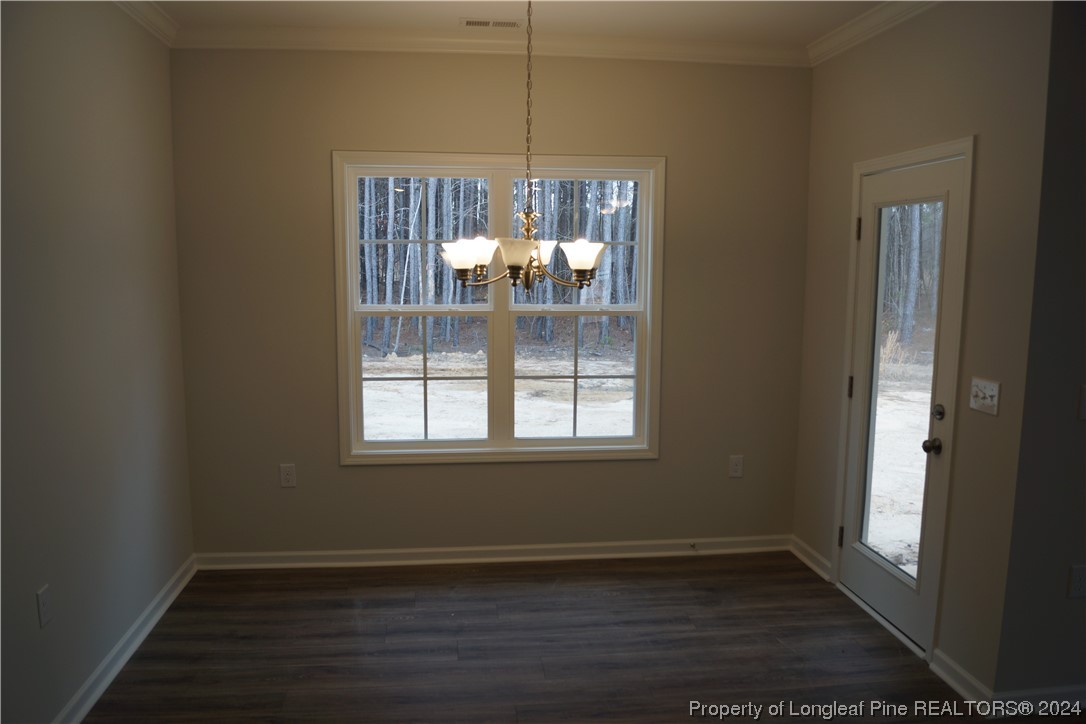111 Knotts Berry Road Bunnlevel, NC 28323 - Photo 25 of 32 an empty room with wooden floor and windows