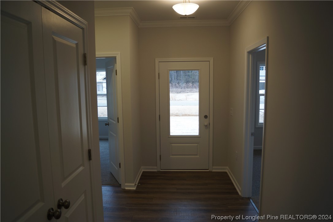 111 Knotts Berry Road Bunnlevel, NC 28323 - Photo 4 of 32 a view of an empty room with wooden floor and a window