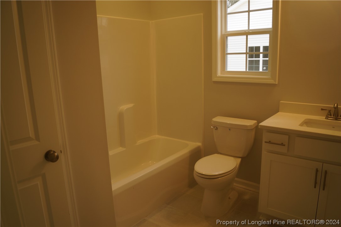 111 Knotts Berry Road Bunnlevel, NC 28323 - Photo 8 of 32 a bathroom with a toilet and a sink