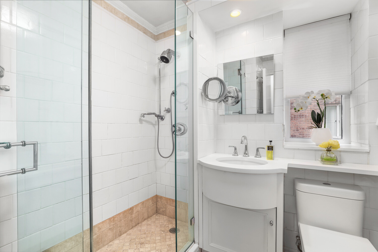135 East 71st Street, Unit 3D Manhattan, NY 10021 - Photo 6 of 11 a bathroom with a sink a toilet and shower