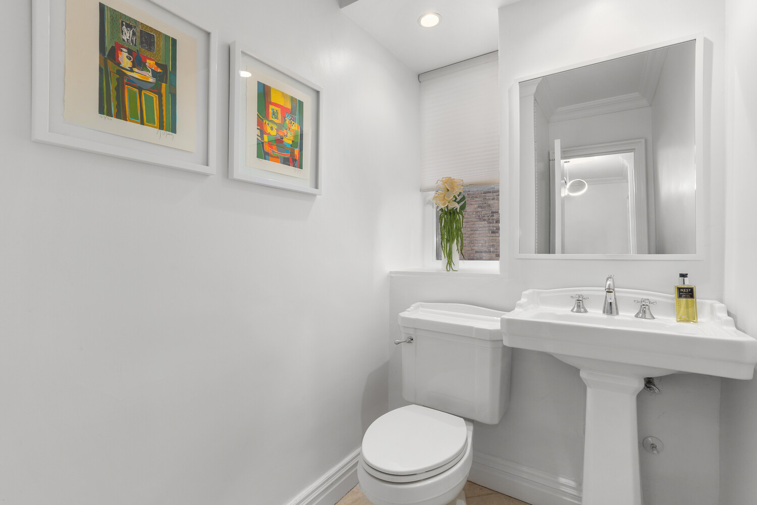 135 East 71st Street, Unit 3D Manhattan, NY 10021 - Photo 7 of 11 a bathroom with a toilet a sink and mirror