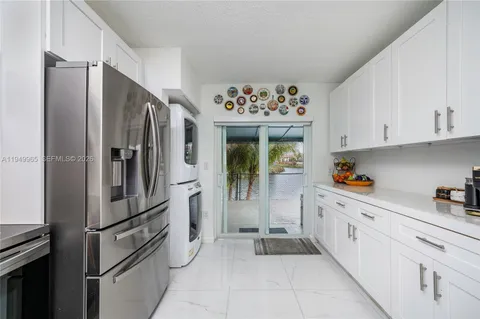 a kitchen with stainless steel appliances a refrigerator and cabinets