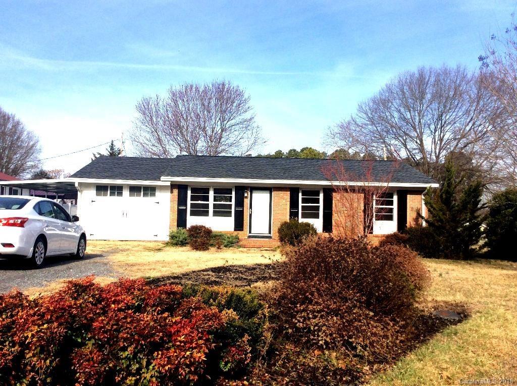 1305 Miles Road Dallas, NC 28034 - Photo 1 of 12 a front view of a house with a yard and garage