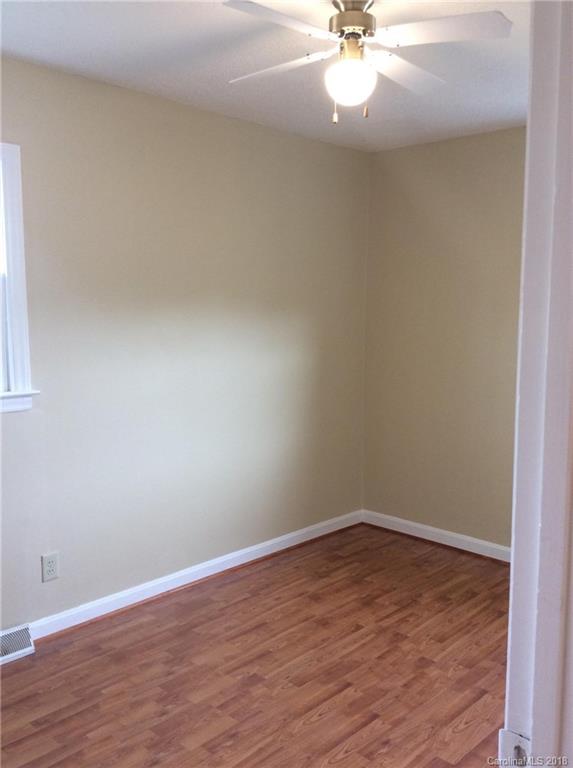 1305 Miles Road Dallas, NC 28034 - Photo 6 of 12 a view of a room with wooden floor and a ceiling fan
