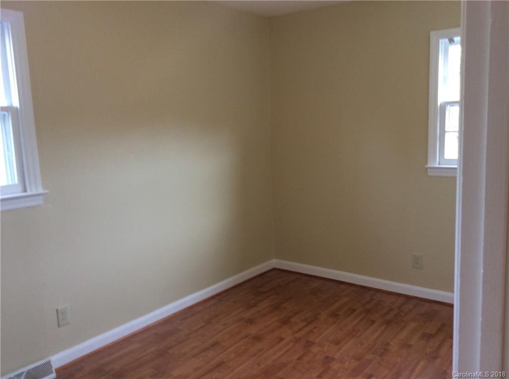 1305 Miles Road Dallas, NC 28034 - Photo 7 of 12 a view of an empty room with wooden floor and a window