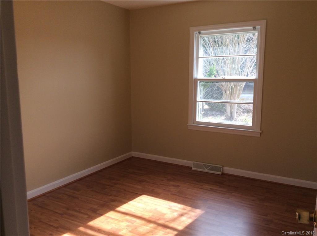 1305 Miles Road Dallas, NC 28034 - Photo 8 of 12 an empty room with wooden floor and windows