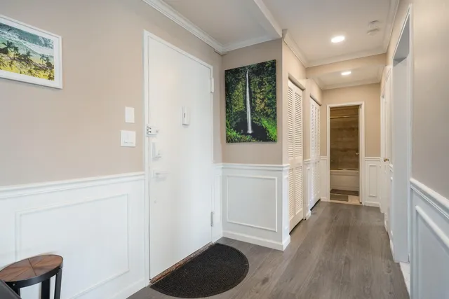 a view of entryway with window and wooden floor