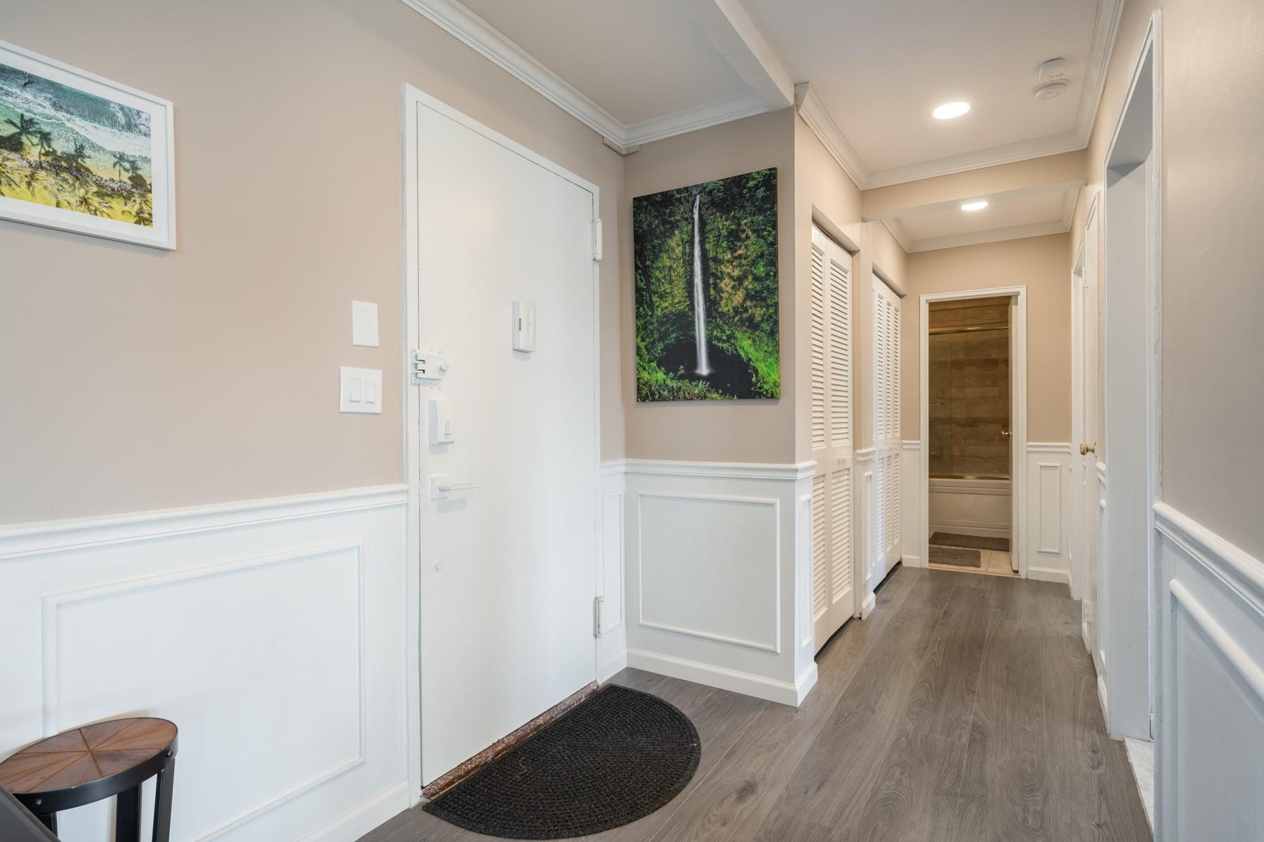 a view of entryway with window and wooden floor