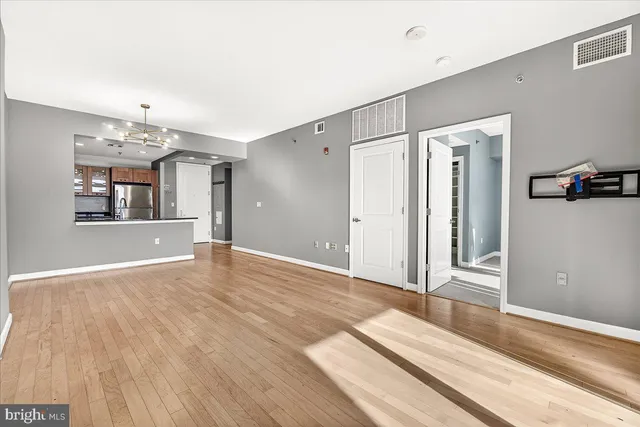 a view of a room with wooden floor and staircase